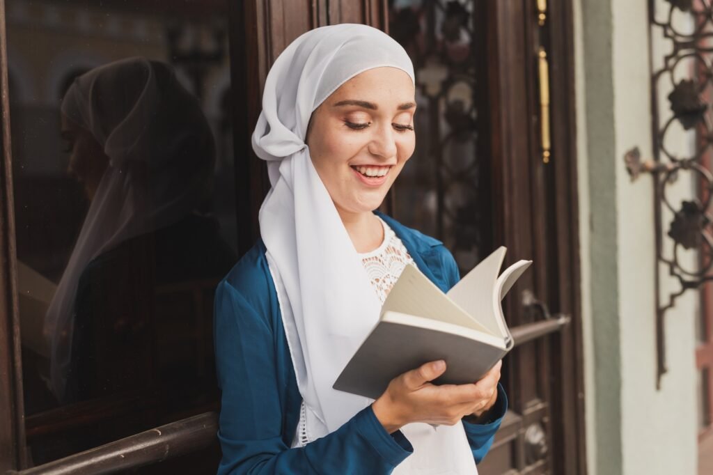 Young muslim girl wears hijab with diary book. Islamic student and knowledge concept